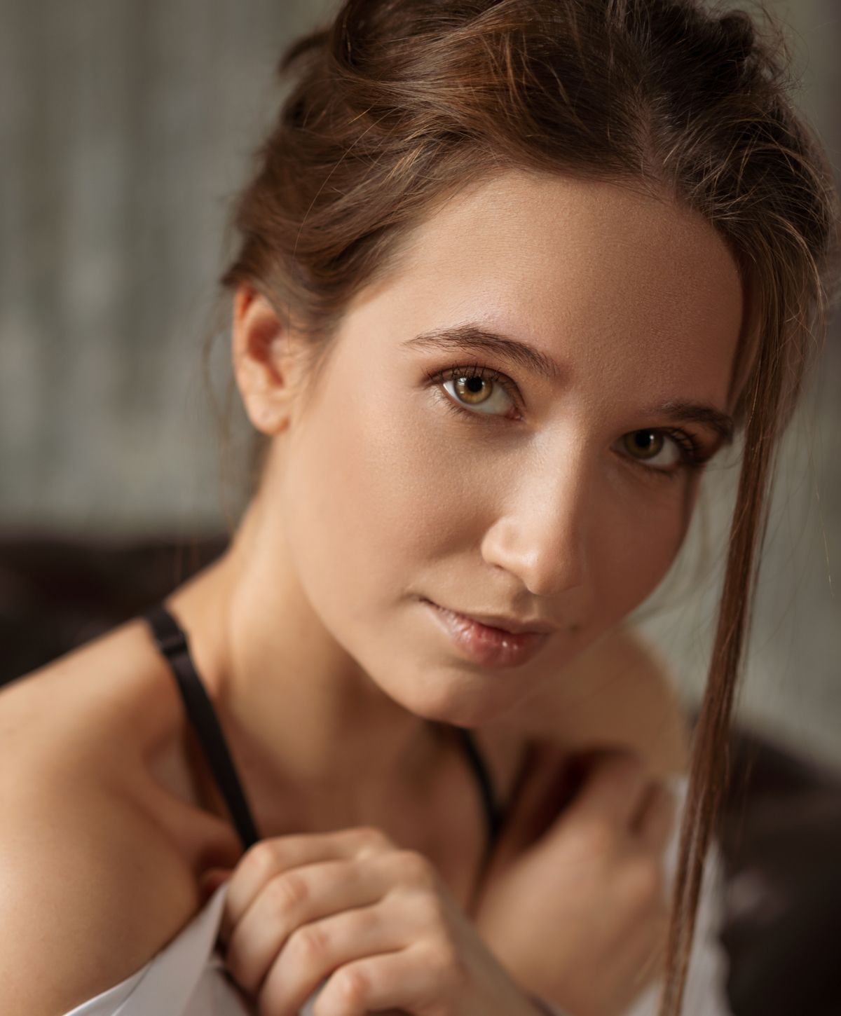 Woman gently stretching her foot on a sofa.