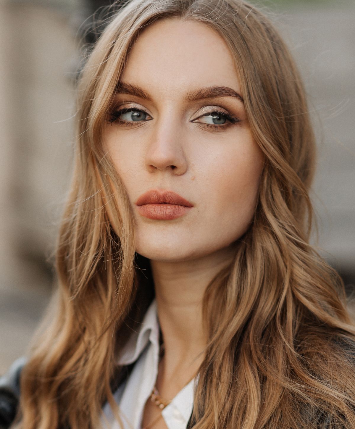 Portrait of a woman with long wavy hair.