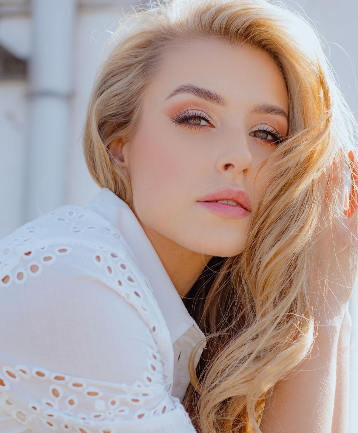 Medical-grade skincare model with long blonde hair, soft expression.