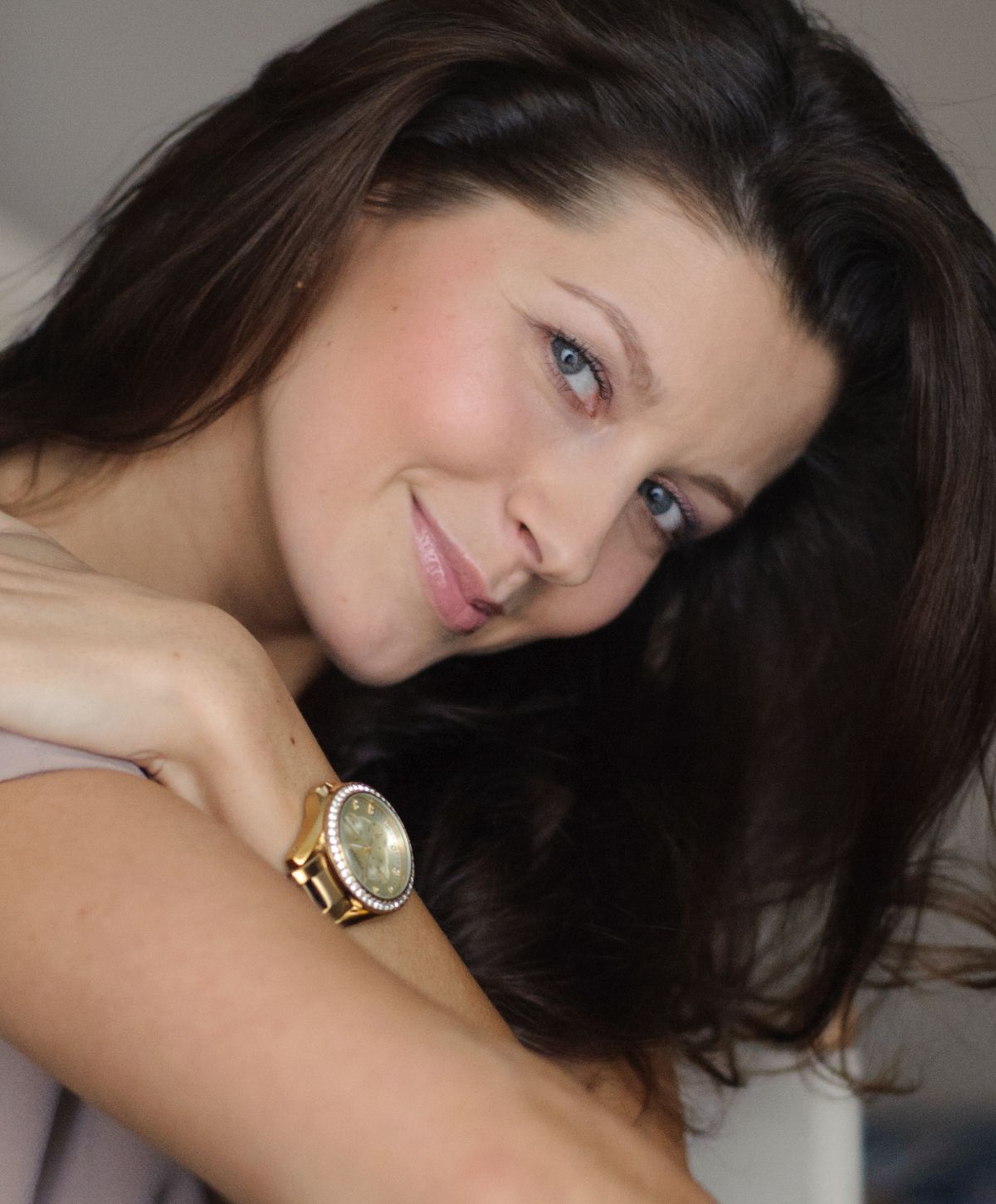 Portrait of a Mission Viejo under eye filler model with long dark hair.