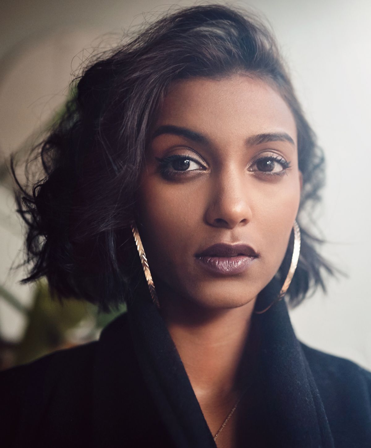 Close-up portrait of a PRP injections model with earrings.