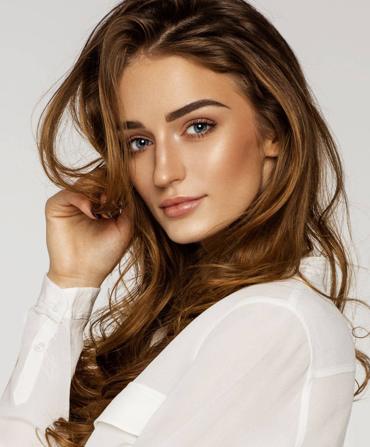 Orange County Juvederm model with long hair and soft expression.