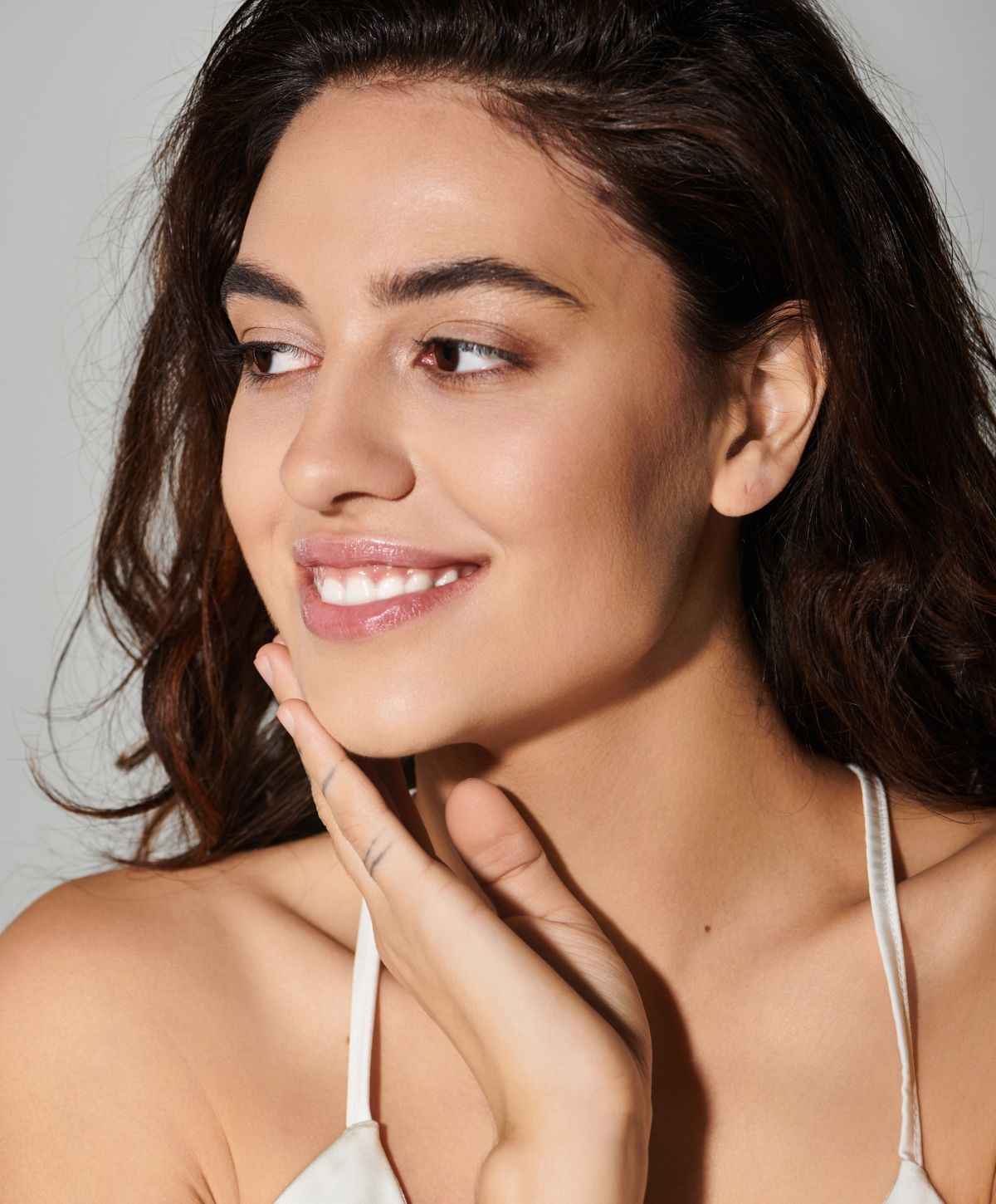 Woman smiling with soft, natural makeup.