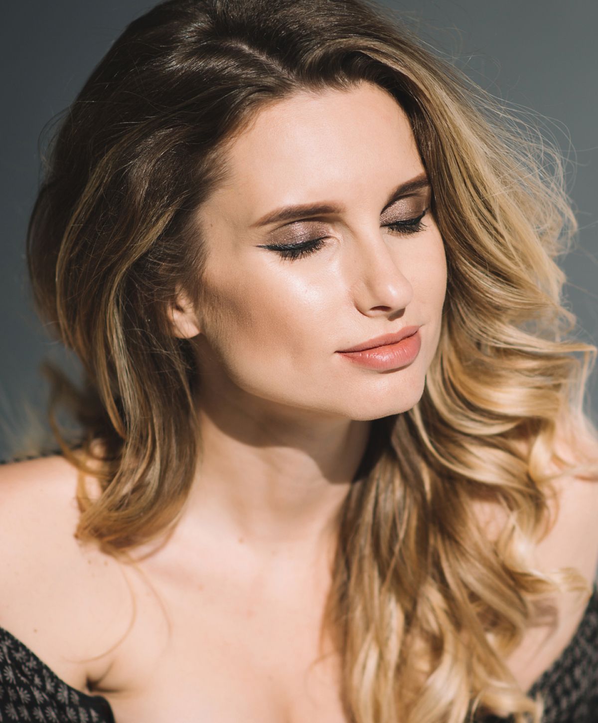 Orange County HydraFacial model with flowing hair and closed eyes.