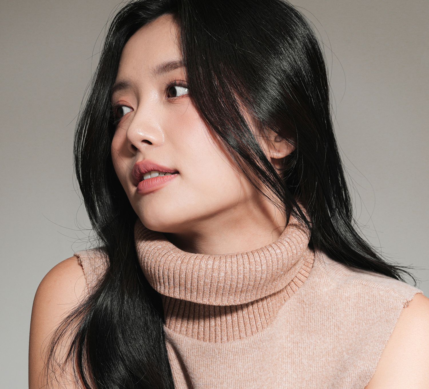 Profile of an Orange County med spa model with long black hair.