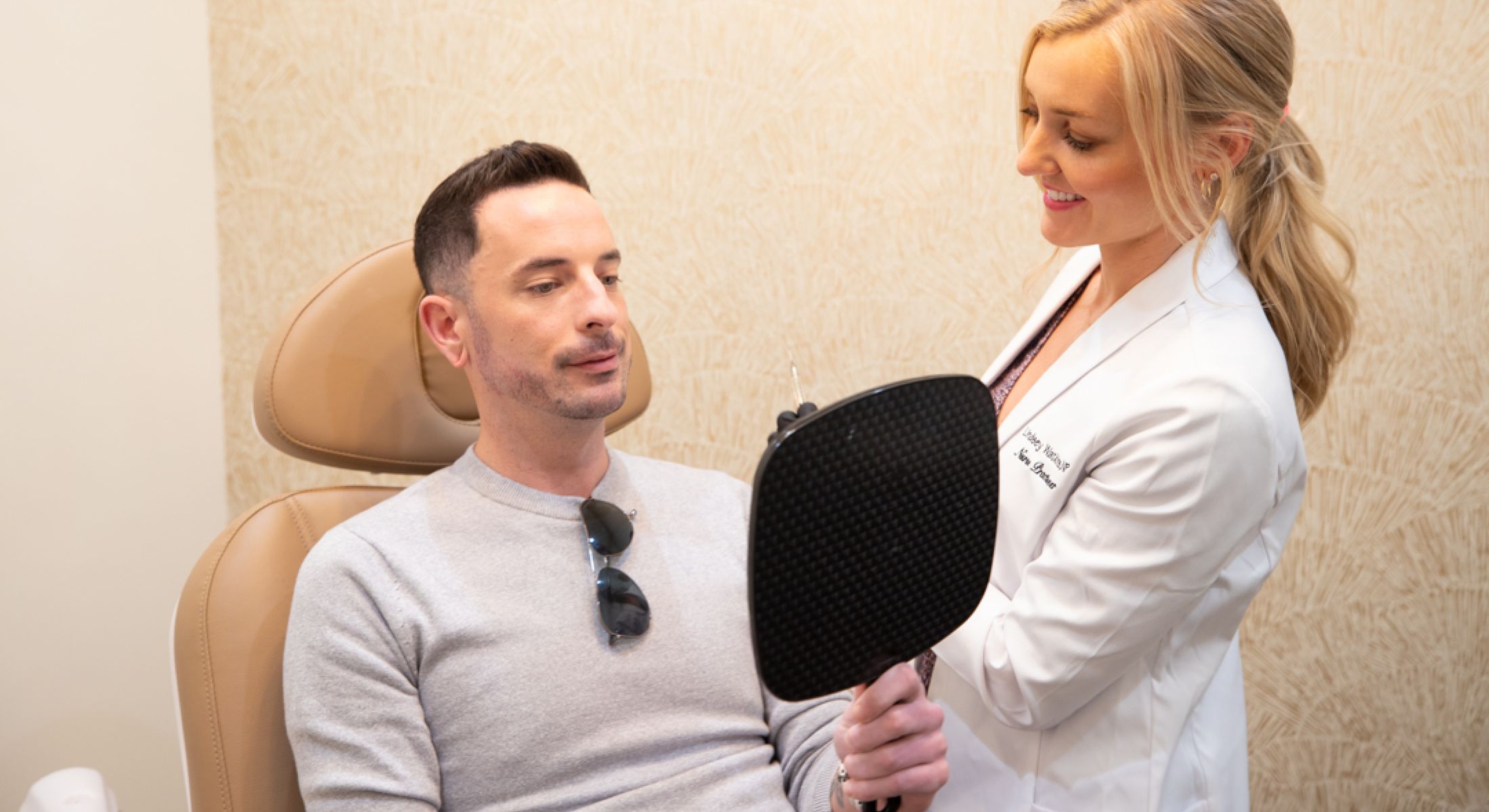 Mission Viejo hair restoration patient reviewing results with a medical professional.