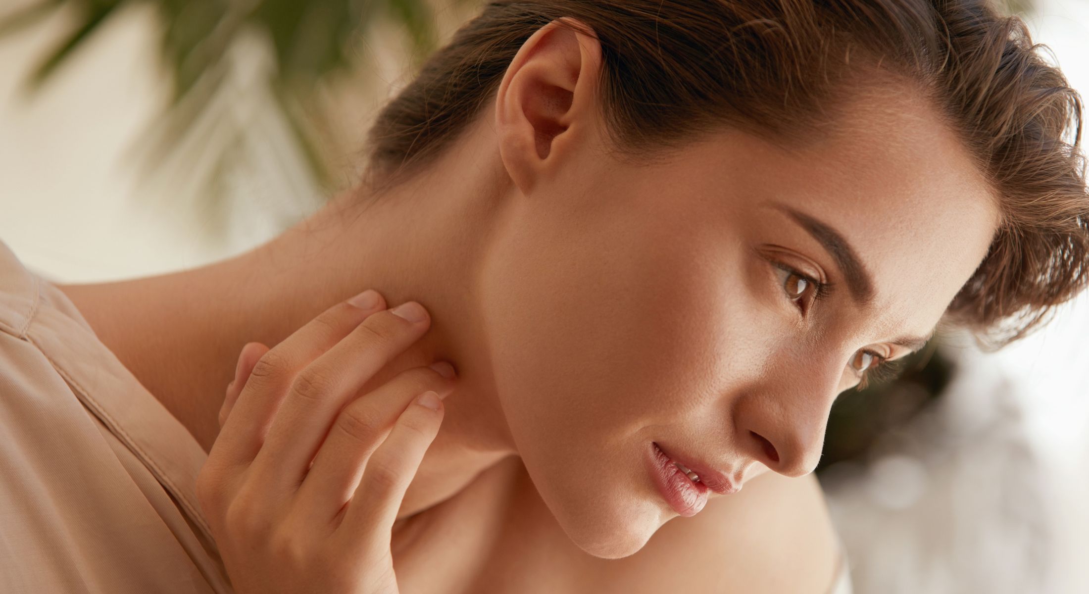 Mission Viejo lines, wrinkles and crepey skin treatment model gently touching her neck.