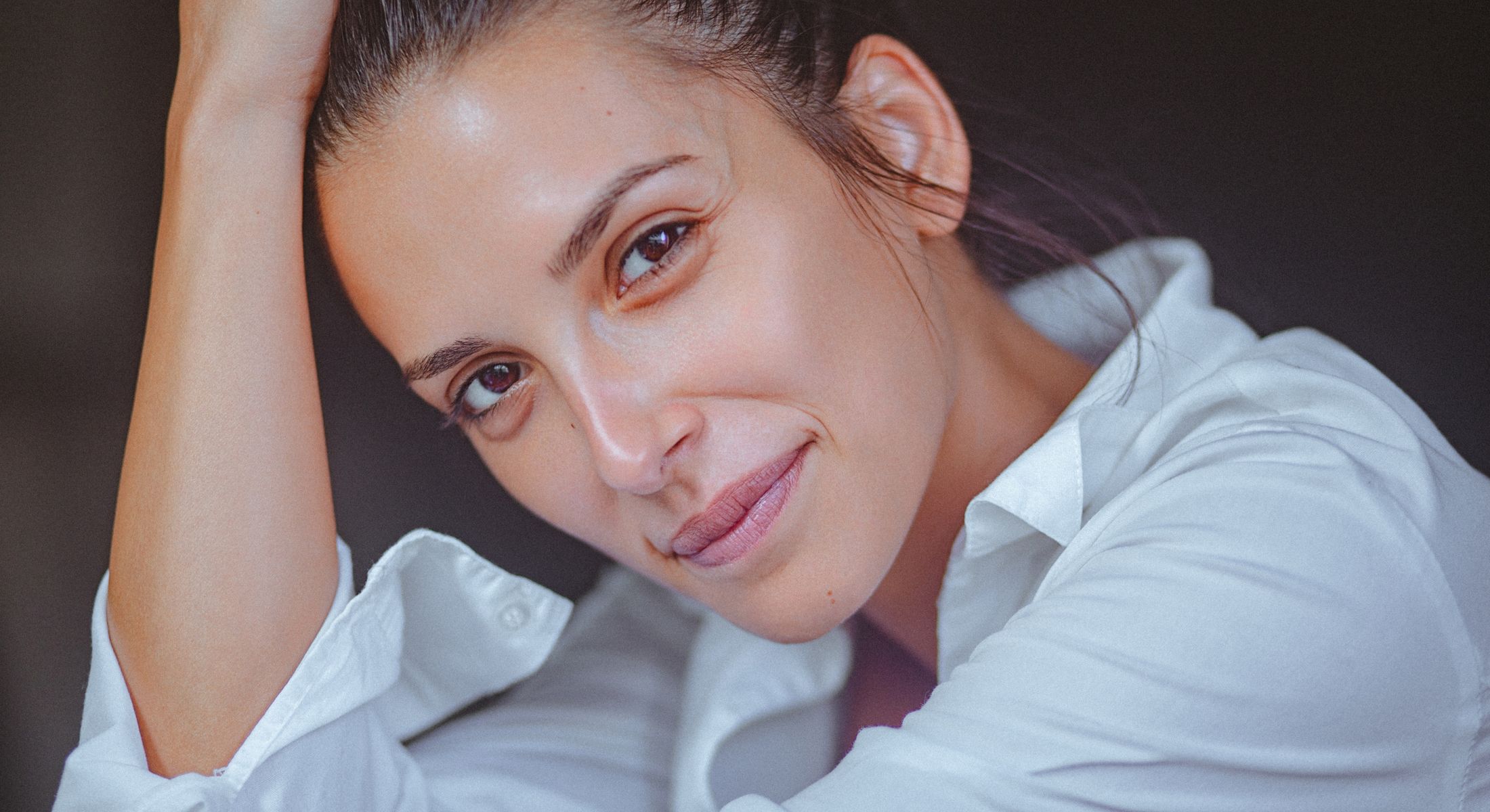 Mission Viejo hyperpigmentation treatment model in a white shirt, smiling softly.