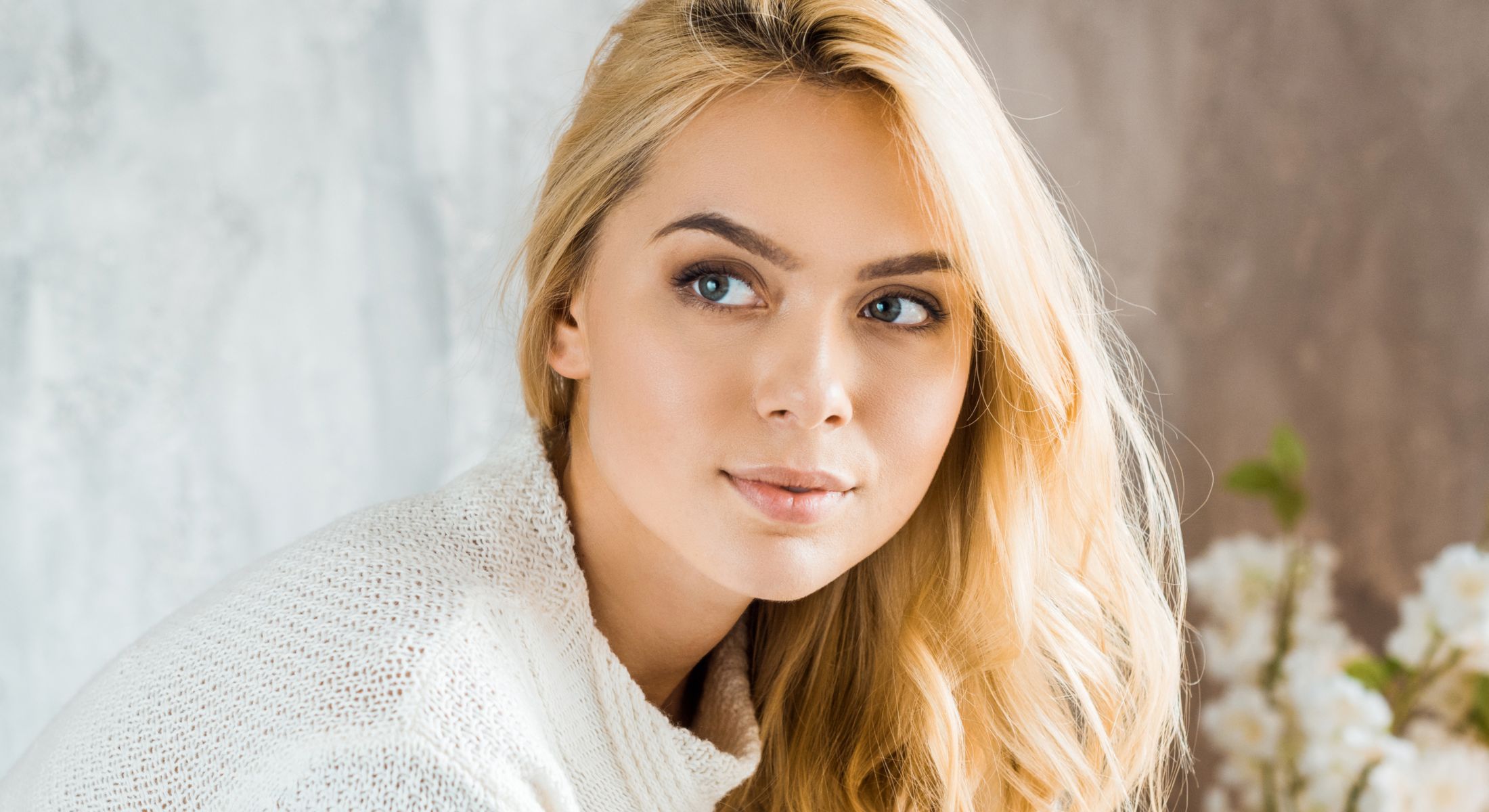 Rancho Santa Margarita dermal fillers model with blonde hair and soft smile.