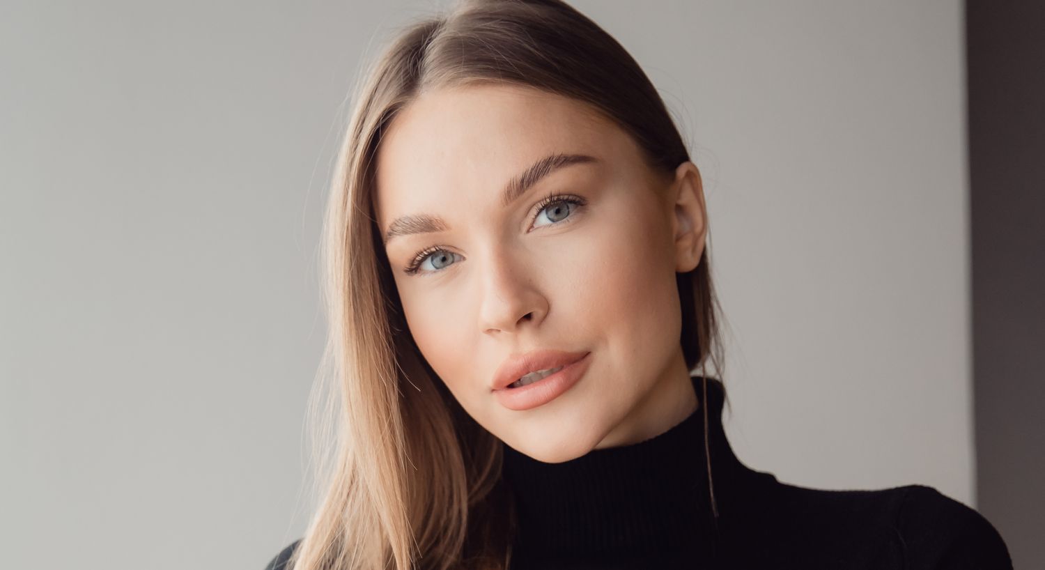 Young Orange County Sofwave model with long hair and natural makeup.