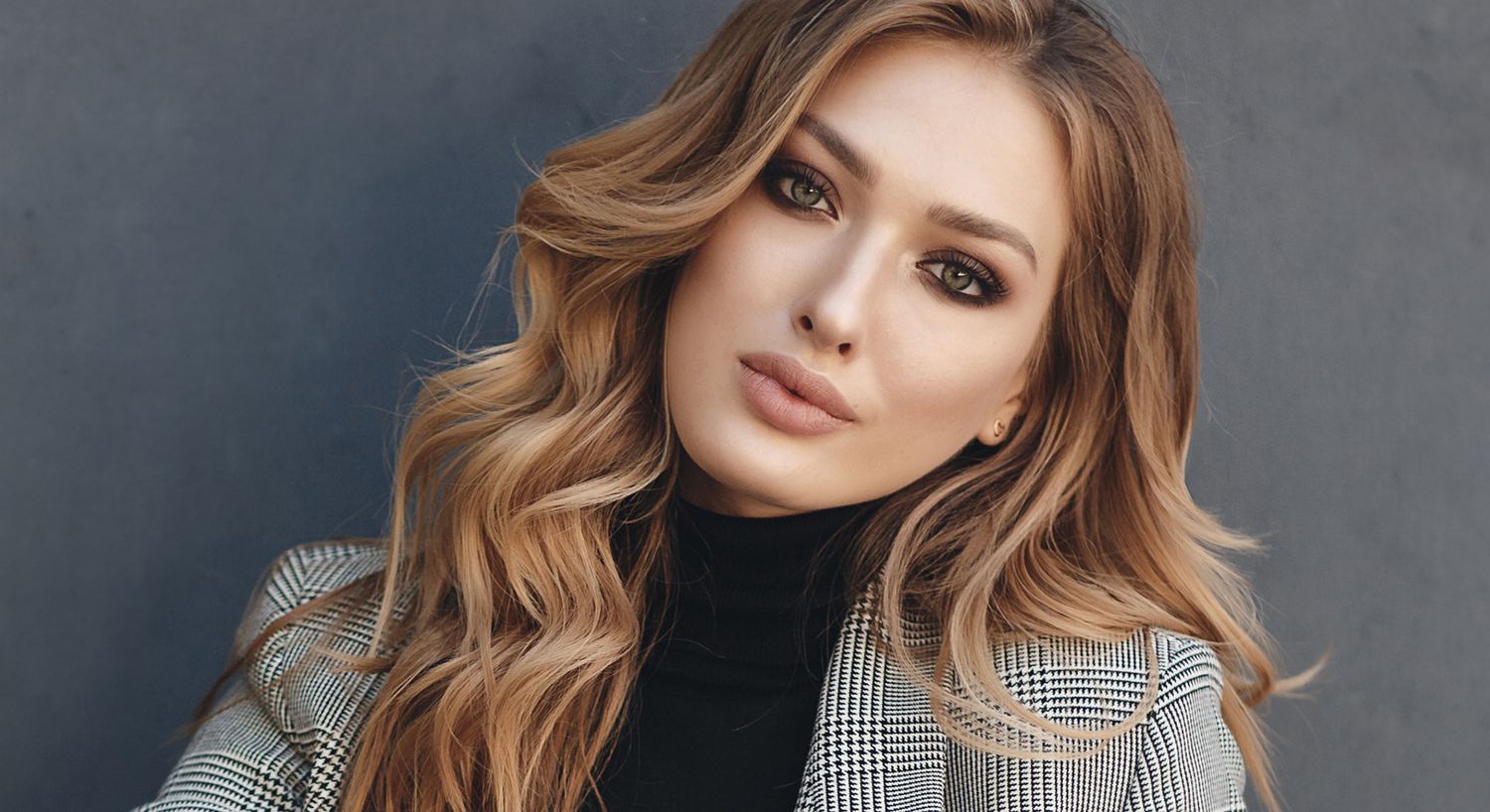 Orange County rf microneedling model with long hair in stylish outfit.